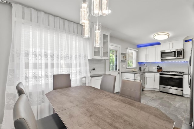 4401 Kingston Ave, Lisle, IL 60532 - kitchen featuring appliances with stainless steel finishes, decorative backsplash, white cabinets, and a sink