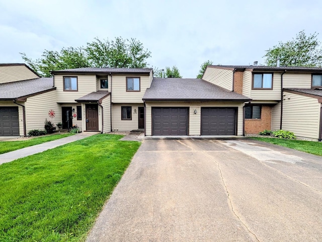 2176 Harbortown Cir Unit 2176, Champaign, IL 61821 - townhome / multi-family property with a garage, asphalt driveway, and a front lawn