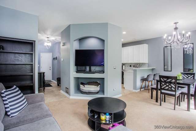 living area with a chandelier, light colored carpet, baseboards, recessed lighting, and built in features