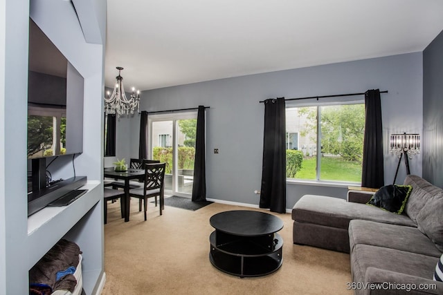 living area featuring a chandelier, plenty of natural light, and light colored carpet