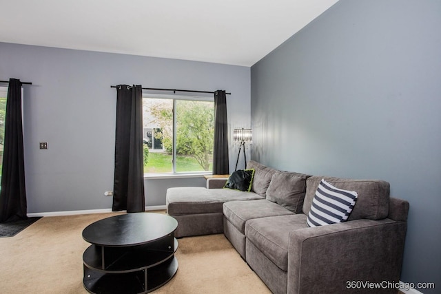 living area featuring carpet and baseboards