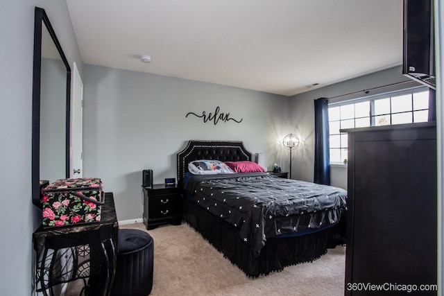carpeted bedroom featuring baseboards