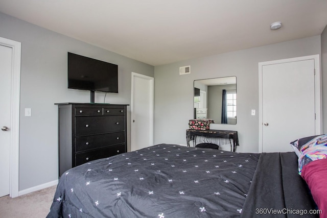 bedroom with carpet floors and baseboards