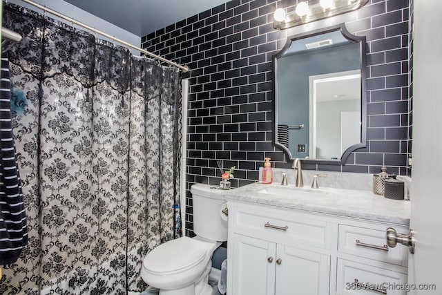 bathroom featuring tile walls, vanity, toilet, and a shower with curtain
