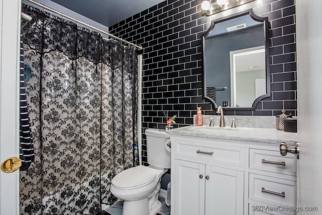 bathroom featuring tile walls, toilet, vanity, and a shower with shower curtain