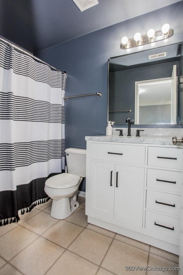 full bath featuring tile patterned floors, vanity, toilet, and curtained shower