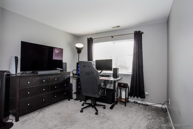 office space featuring light carpet and baseboards