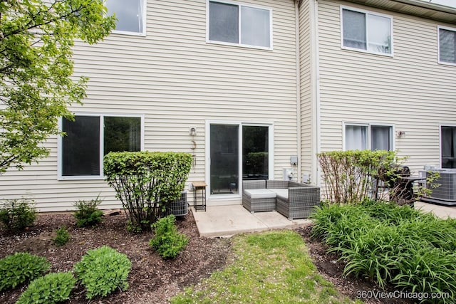 rear view of property with a patio area, central air condition unit, and outdoor lounge area