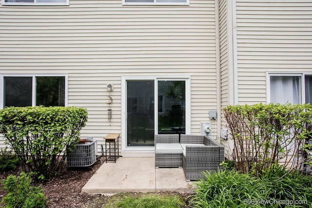 back of property featuring a patio and central AC