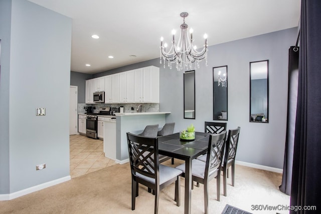 dining space with a chandelier, light colored carpet, baseboards, recessed lighting, and light tile patterned floors