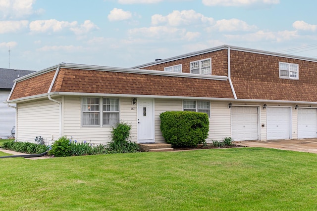 1409 E Stonehenge Dr Unit 1409, Sycamore, IL 60178 - view of front of home with a shingled roof, a front yard, mansard roof, and driveway