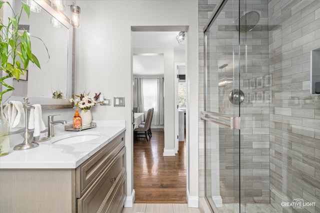 521 N Elm St, Hillside, IL 60162 - ensuite bathroom featuring a stall shower, vanity, and wood finished floors
