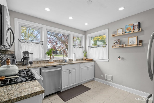 521 N Elm St, Hillside, IL 60162 - kitchen with stainless steel appliances, a sink, light stone countertops, baseboards, and recessed lighting
