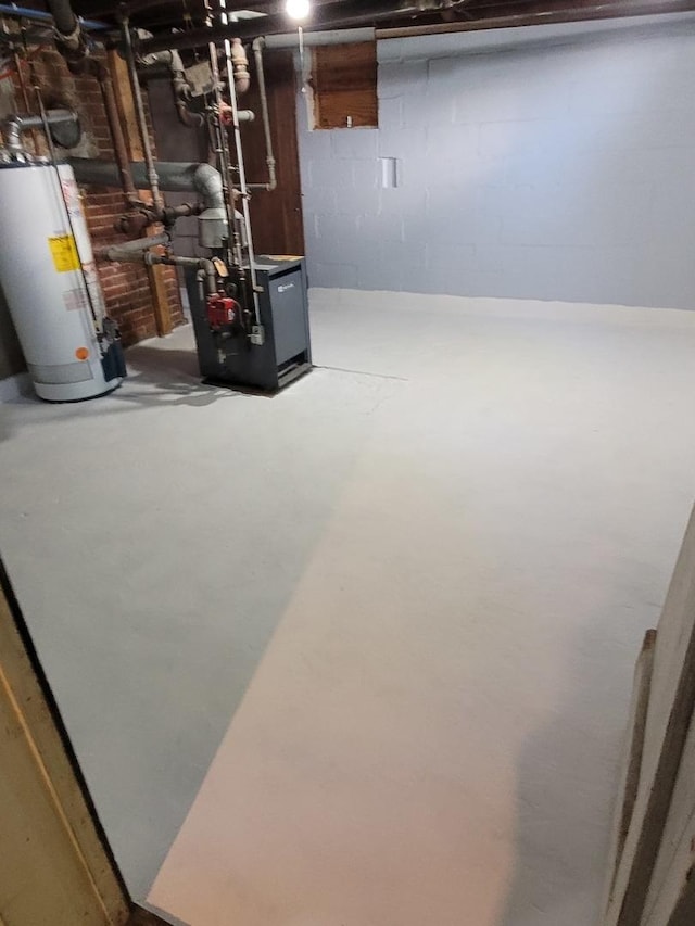 442 High St, Buda, IL 61314 - unfinished basement featuring water heater and a heating unit