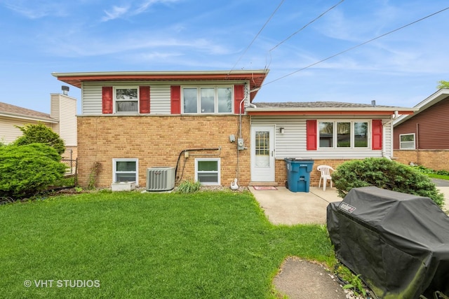 130 W Natalie Ln, Addison, IL 60101 - back of property featuring central AC, brick siding, a lawn, and a patio