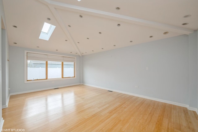 489 Good Ave, Des Plaines, IL 60016 - spare room featuring a skylight, light wood finished floors, and baseboards