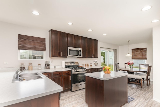 3917 Kristen Ct, Plano, IL 60545 - kitchen featuring stainless steel appliances, a sink, light countertops, light wood-style floors, and recessed lighting