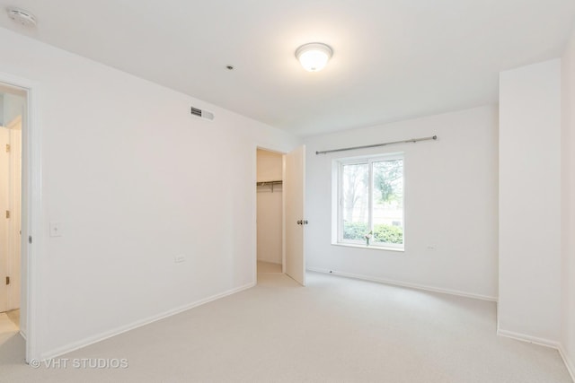 800 Ridge Rd Unit 108, Wilmette, IL 60091 - unfurnished bedroom featuring light carpet, baseboards, a spacious closet, and a closet