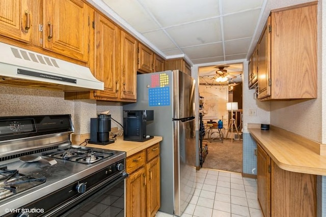 6437 Oak Forest Ave Unit 1E, Tinley Park, IL 60477 - kitchen featuring stainless steel appliances, under cabinet range hood, light countertops, brown cabinetry, and light tile patterned flooring