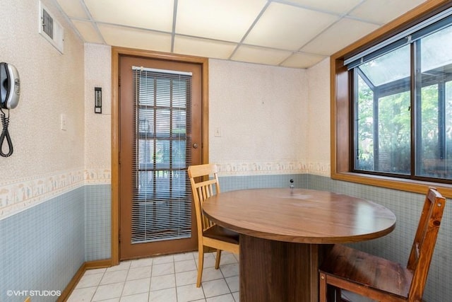 6437 Oak Forest Ave Unit 1E, Tinley Park, IL 60477 - dining room featuring a paneled ceiling, wallpapered walls, and light tile patterned floors