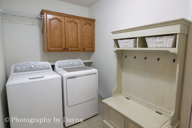 584 Chase Ct, Bourbonnais, IL 60914 - laundry room featuring independent washer and dryer, cabinet space, and light tile patterned floors