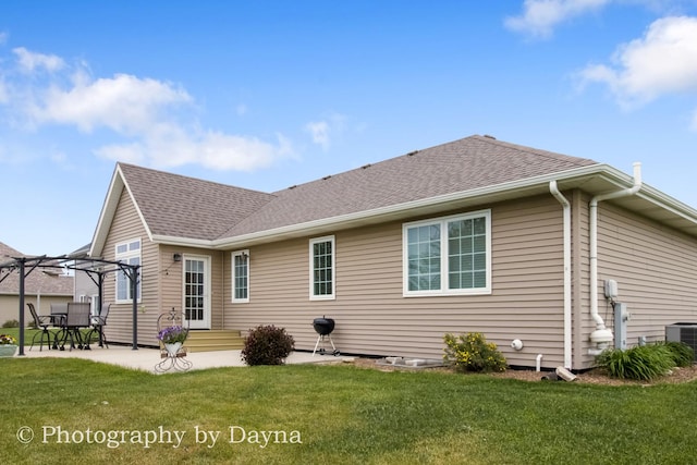 584 Chase Ct, Bourbonnais, IL 60914 - back of house with a pergola, a lawn, central AC, a patio area, and roof with shingles
