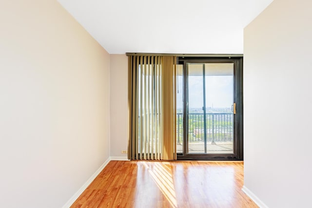 2901 S Michigan Ave Unit 1706, Chicago, IL 60616 - empty room with wood finished floors, baseboards, and floor to ceiling windows
