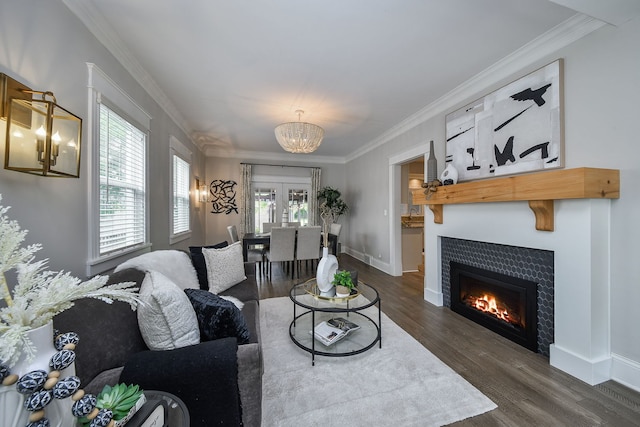 549 S Main St, Naperville, IL 60540 - living room featuring a chandelier, dark wood finished floors, crown molding, a tiled fireplace, and baseboards