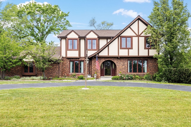 60 Romiga Ln, Palos Park, IL 60464 - tudor-style house featuring a front yard, stucco siding, and brick siding