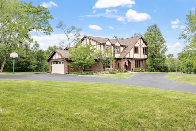 60 Romiga Ln, Palos Park, IL 60464 - tudor home with asphalt driveway, brick siding, a front lawn, and board and batten siding