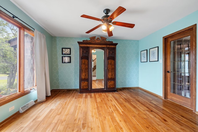 60 Romiga Ln, Palos Park, IL 60464 - spare room featuring wallpapered walls, light wood-style flooring, baseboards, and ceiling fan