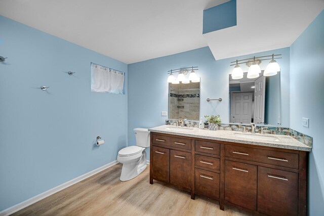 26238 W Hickory Ln, Ingleside, IL 60041 - full bathroom with wood finished floors, toilet, tiled shower, double vanity, and baseboards