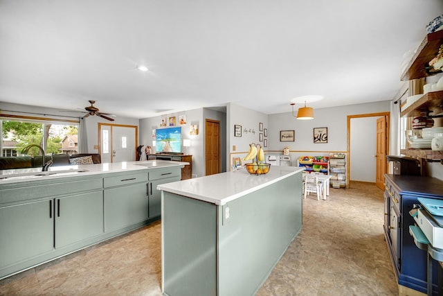 26238 W Hickory Ln, Ingleside, IL 60041 - kitchen with green cabinetry, a sink, ceiling fan, light countertops, and a center island