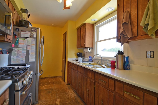 9 Maplewood Ln, Ottawa, IL 61350 - kitchen with a sink, appliances with stainless steel finishes, light countertops, dark wood-type flooring, and tasteful backsplash