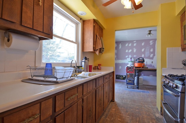 9 Maplewood Ln, Ottawa, IL 61350 - kitchen featuring double oven range, a sink, light countertops, a ceiling fan, and decorative backsplash
