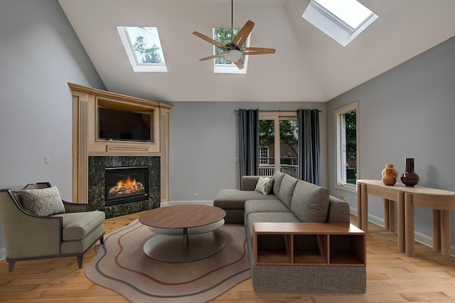 740 Fairmont Ct, Westmont, IL 60559 - living area with a skylight, a premium fireplace, ceiling fan, light wood-style flooring, and high vaulted ceiling