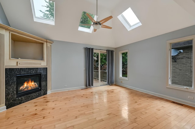 740 Fairmont Ct, Westmont, IL 60559 - unfurnished living room featuring a skylight, baseboards, wood finished floors, a high end fireplace, and high vaulted ceiling