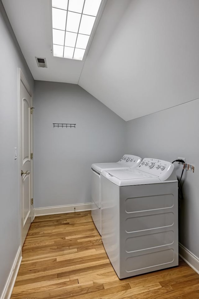 740 Fairmont Ct, Westmont, IL 60559 - laundry room featuring separate washer and dryer, light wood-type flooring, and baseboards