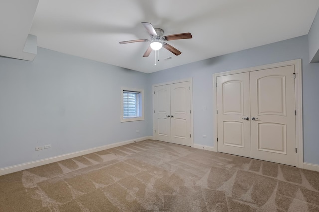 740 Fairmont Ct, Westmont, IL 60559 - unfurnished bedroom with two closets, baseboards, carpet floors, and a ceiling fan