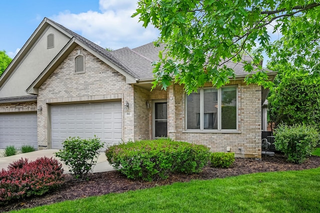 740 Fairmont Ct, Westmont, IL 60559 - view of front of house featuring an attached garage, brick siding, a shingled roof, a front yard, and driveway