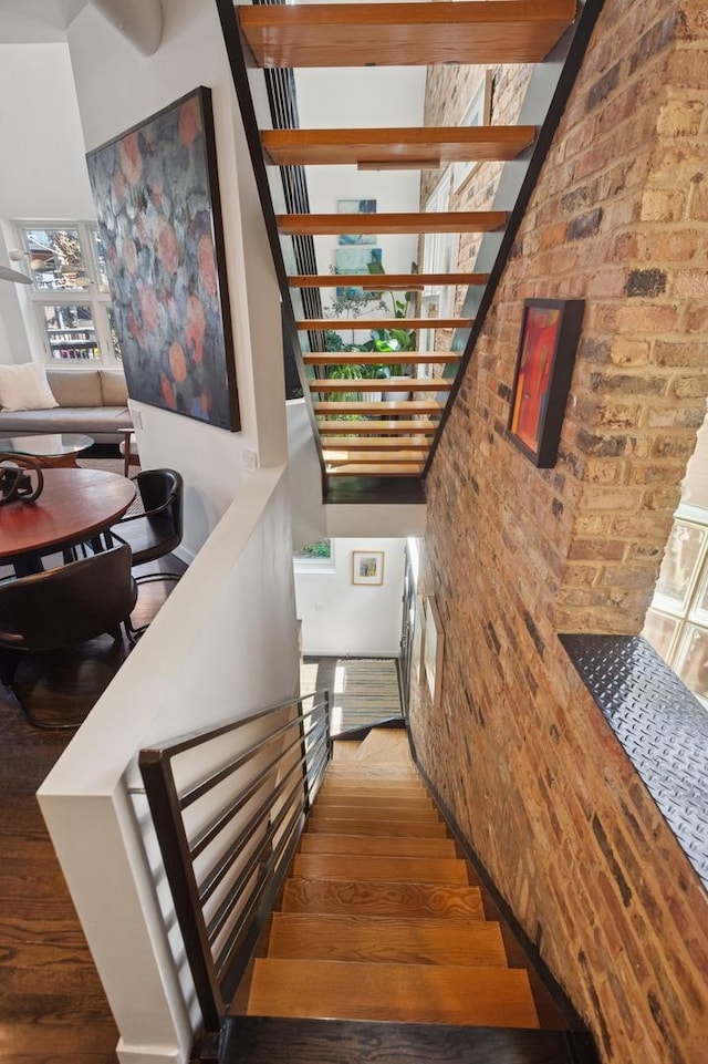 832 W Wolfram St, Chicago, IL 60657 - staircase with wood finished floors and brick wall