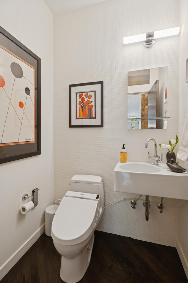 832 W Wolfram St, Chicago, IL 60657 - half bath with wood finished floors, a sink, toilet, and baseboards