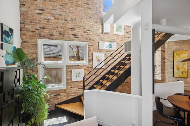 832 W Wolfram St, Chicago, IL 60657 - stairway with brick wall and wood finished floors