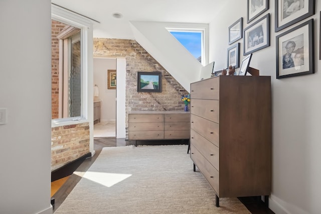 832 W Wolfram St, Chicago, IL 60657 - bedroom featuring brick wall, wood finished floors, and ensuite bathroom