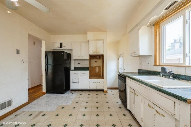 9011 Menard Ave, Morton Grove, IL 60053 - kitchen featuring black appliances, a sink, dark countertops, and backsplash