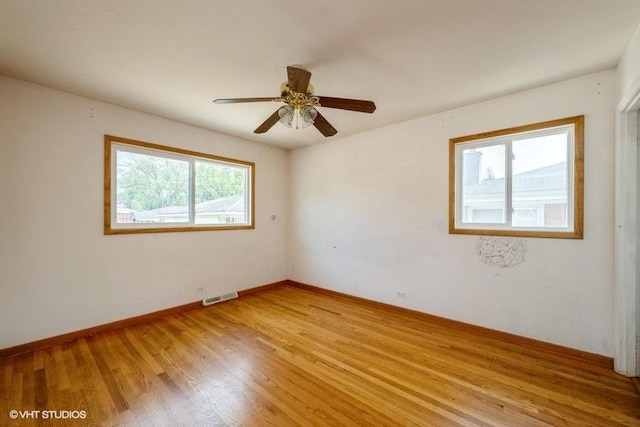 9011 Menard Ave, Morton Grove, IL 60053 - unfurnished room with light wood-style flooring, ceiling fan, and baseboards