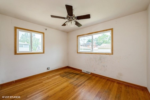 9011 Menard Ave, Morton Grove, IL 60053 - spare room featuring light wood-type flooring, baseboards, and a ceiling fan