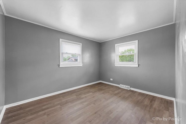 2756 Lancaster Dr, Markham, IL 60428 - empty room with plenty of natural light, ornamental molding, wood finished floors, and baseboards