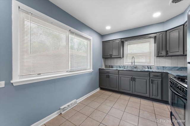 2756 Lancaster Dr, Markham, IL 60428 - kitchen featuring a sink, gray cabinets, black range with gas stovetop, baseboards, and light tile patterned floors