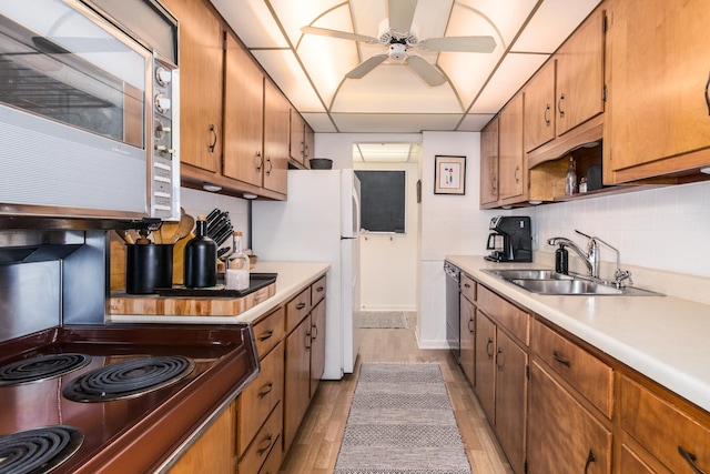 5540 Walnut Ave Unit 23C, Downers Grove, IL 60515 - kitchen with stainless steel microwave, a sink, light countertops, dishwashing machine, and decorative backsplash